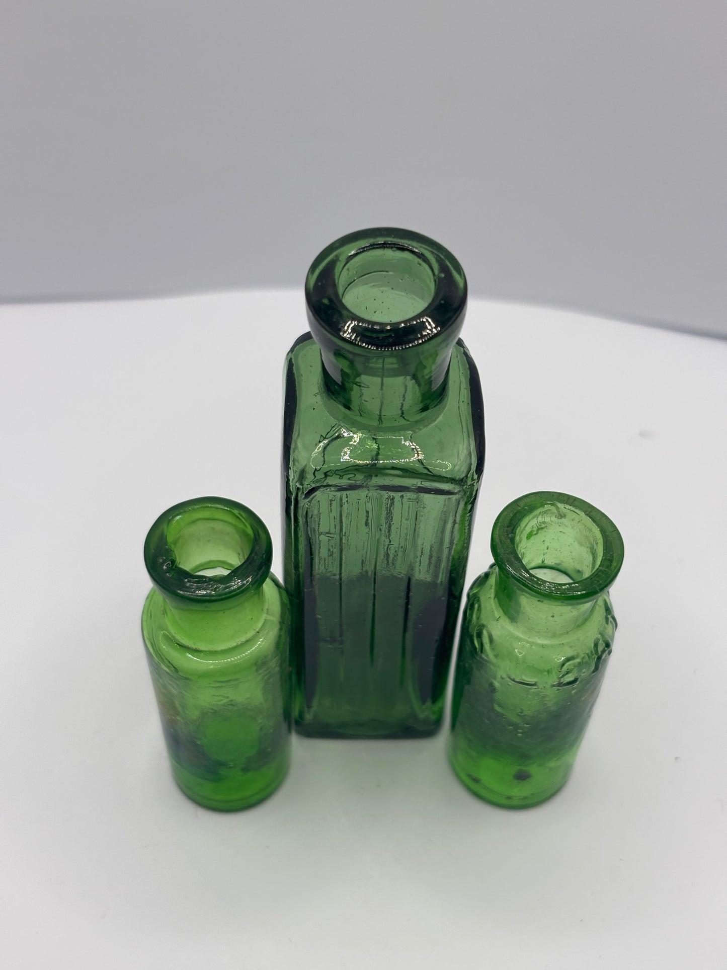 3 old green glass bottles
