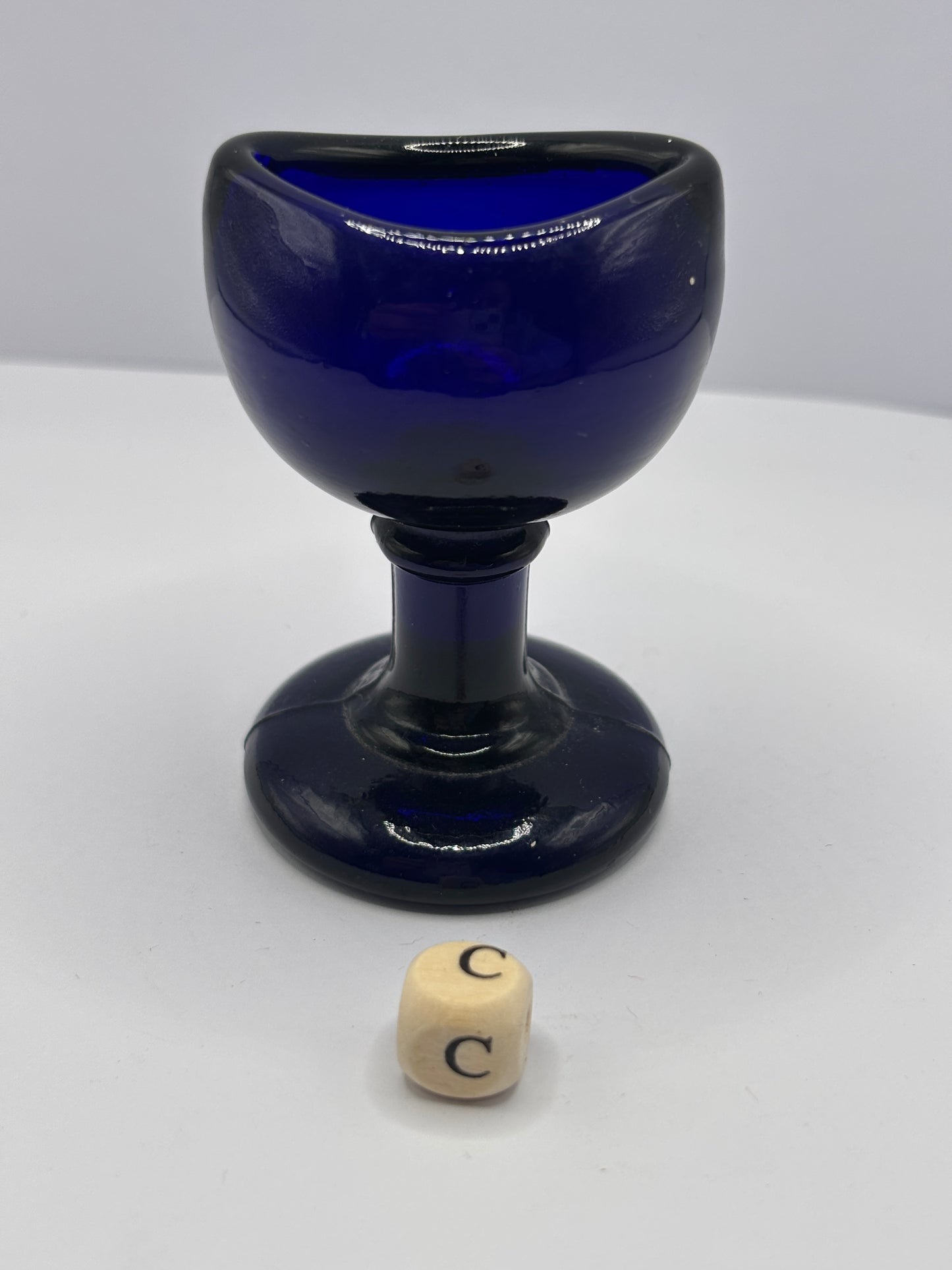 Old blue glass eye bath (c)