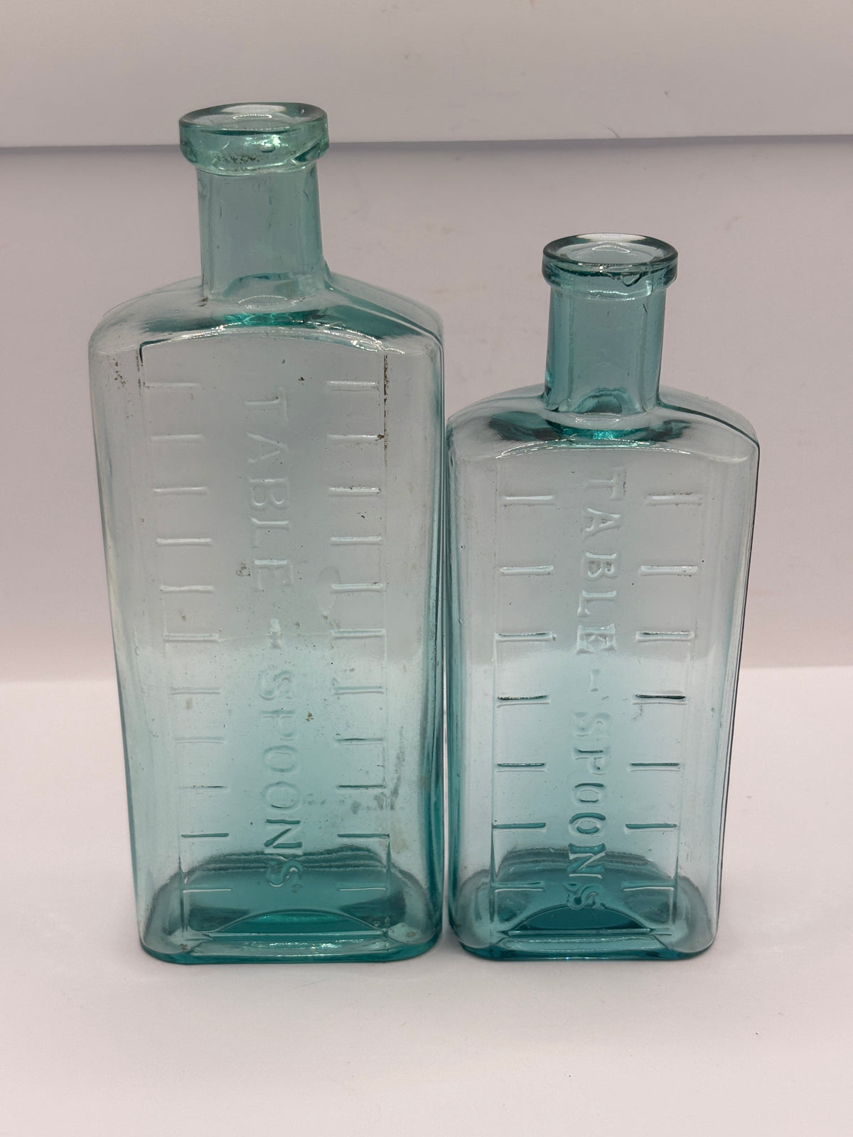 2 old aqua glass medicine bottles, table spoons