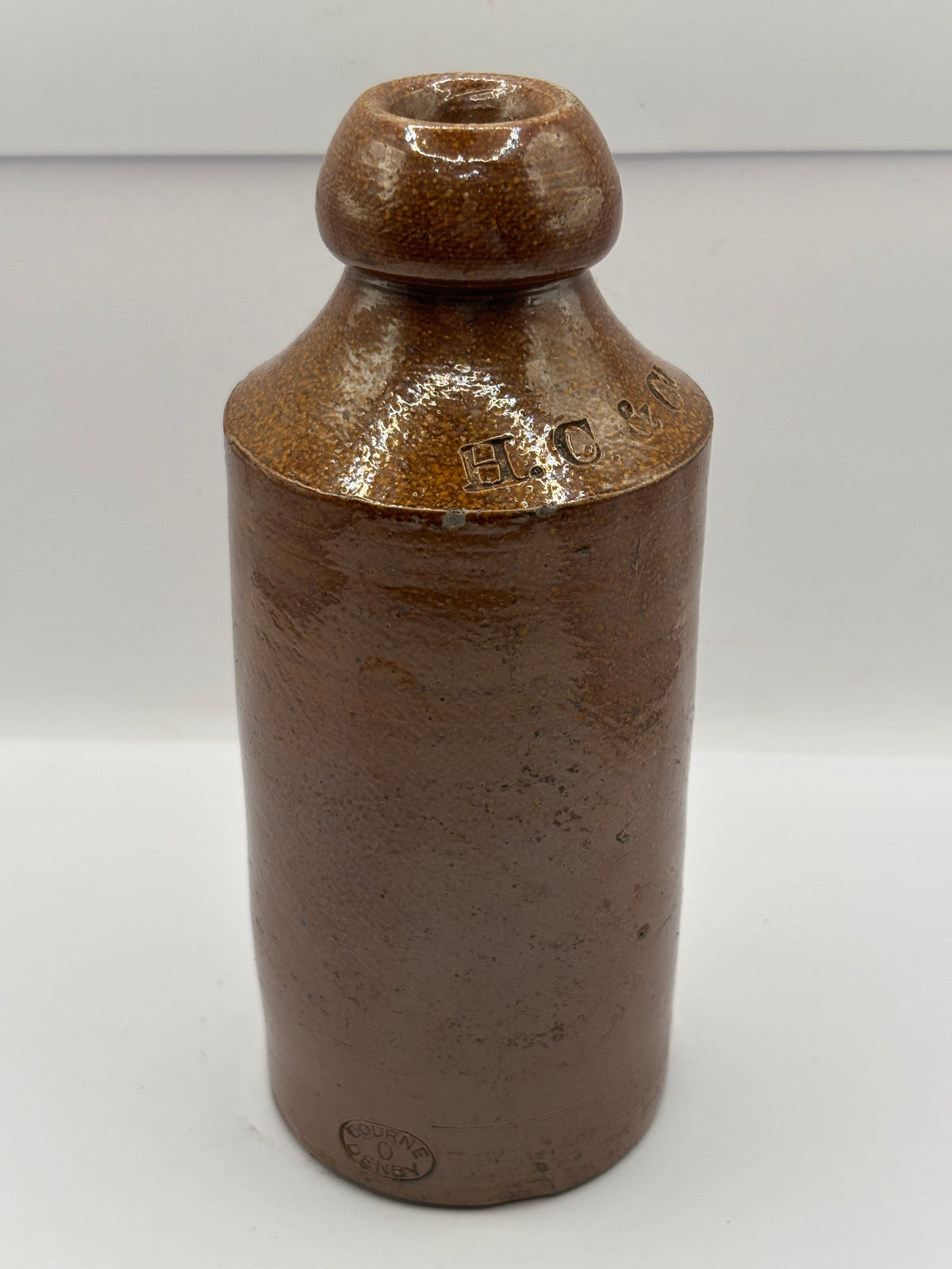 Old impressed stoneware ginger beer bottle, London. Hills chapman & co