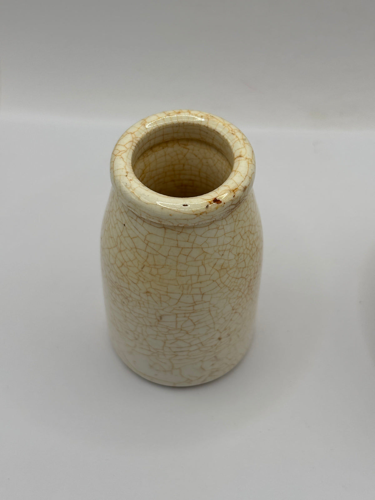 Old plain white stoneware creamer, churn