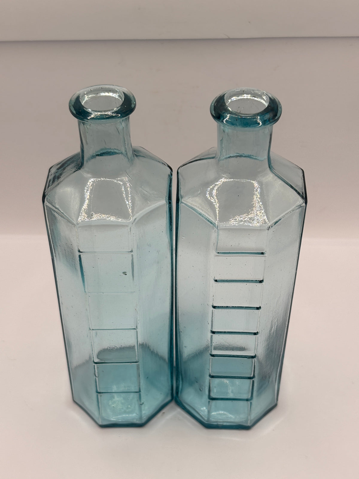 2 old glass medicine bottles