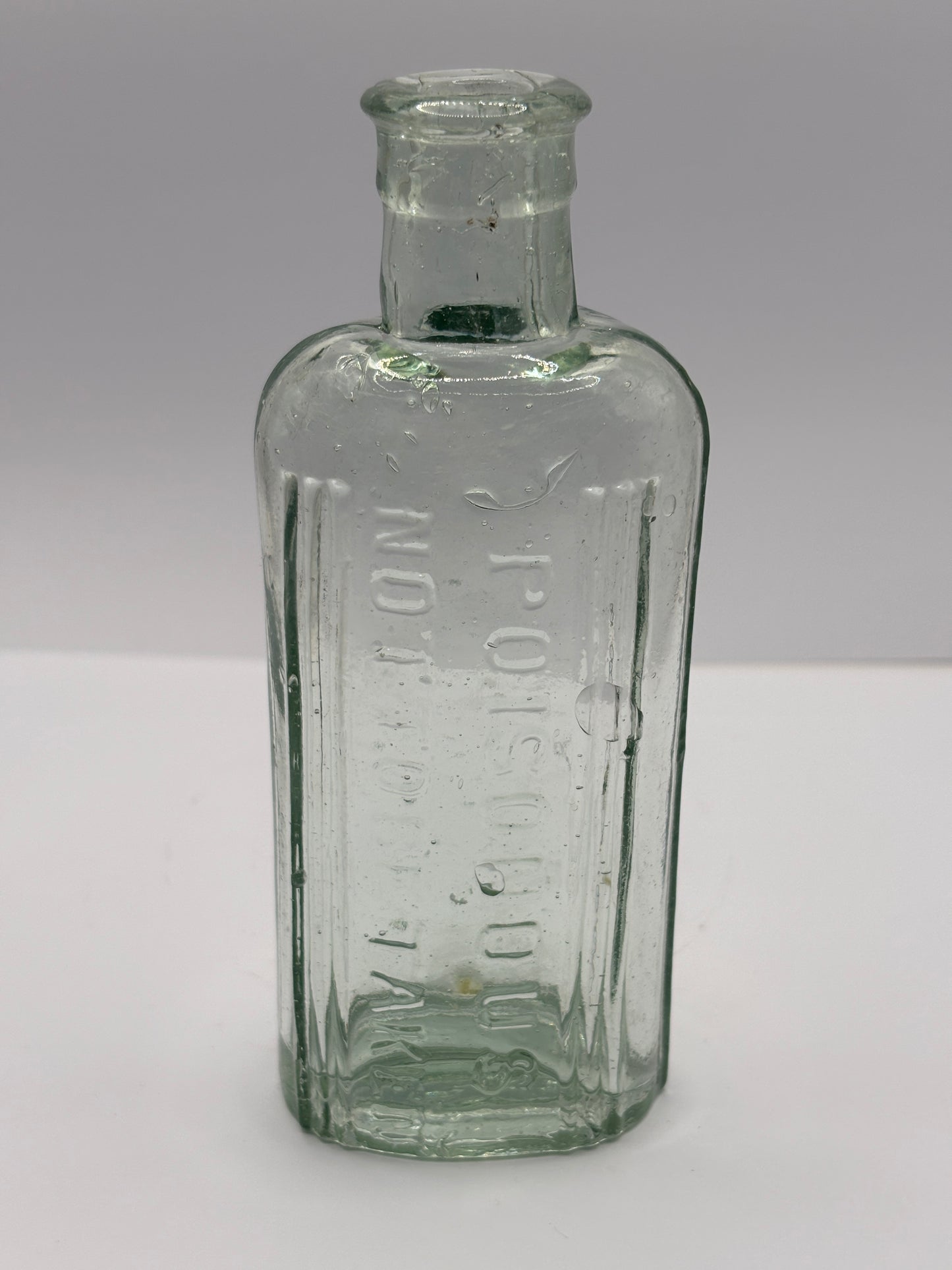 Old aqua glass poison bottle, Poisonous