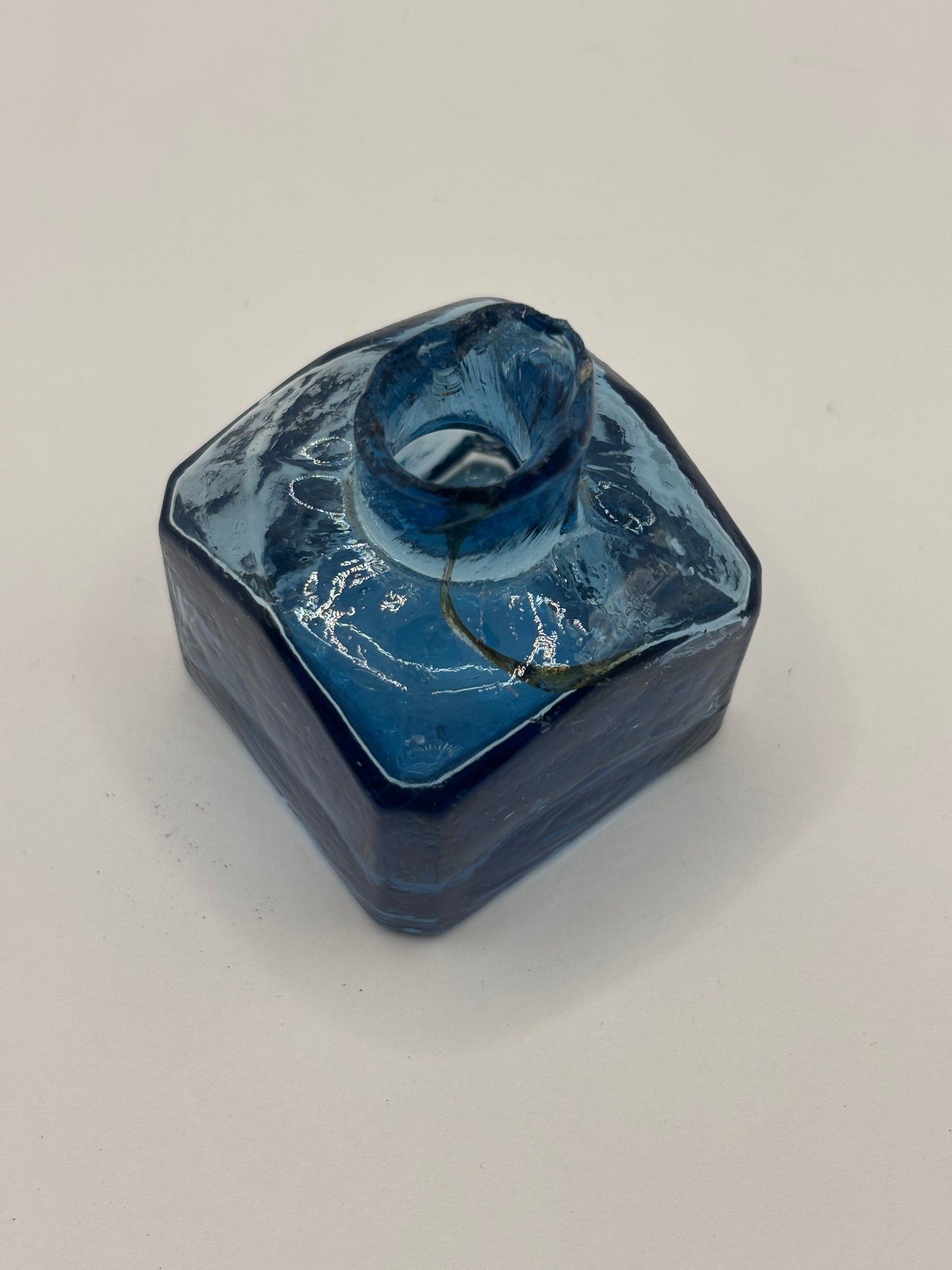 Old blue glass inkwell, penny ink with swirls. Damaged
