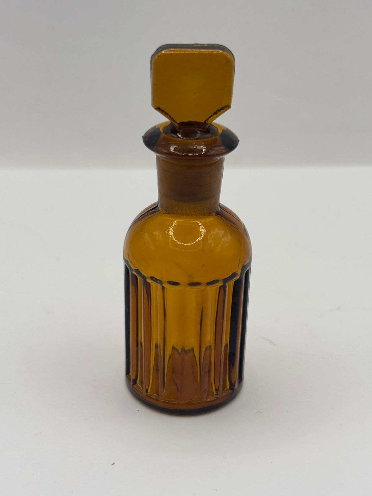 Small amber glass poison bottle with original stopper