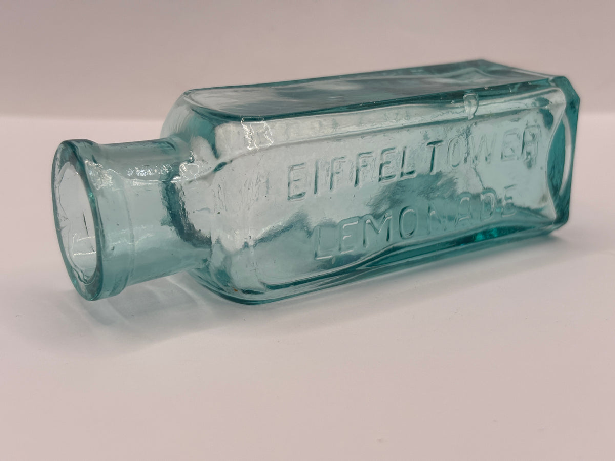 Old aqua glass advertising bottle, Eiffel tower Lemonade