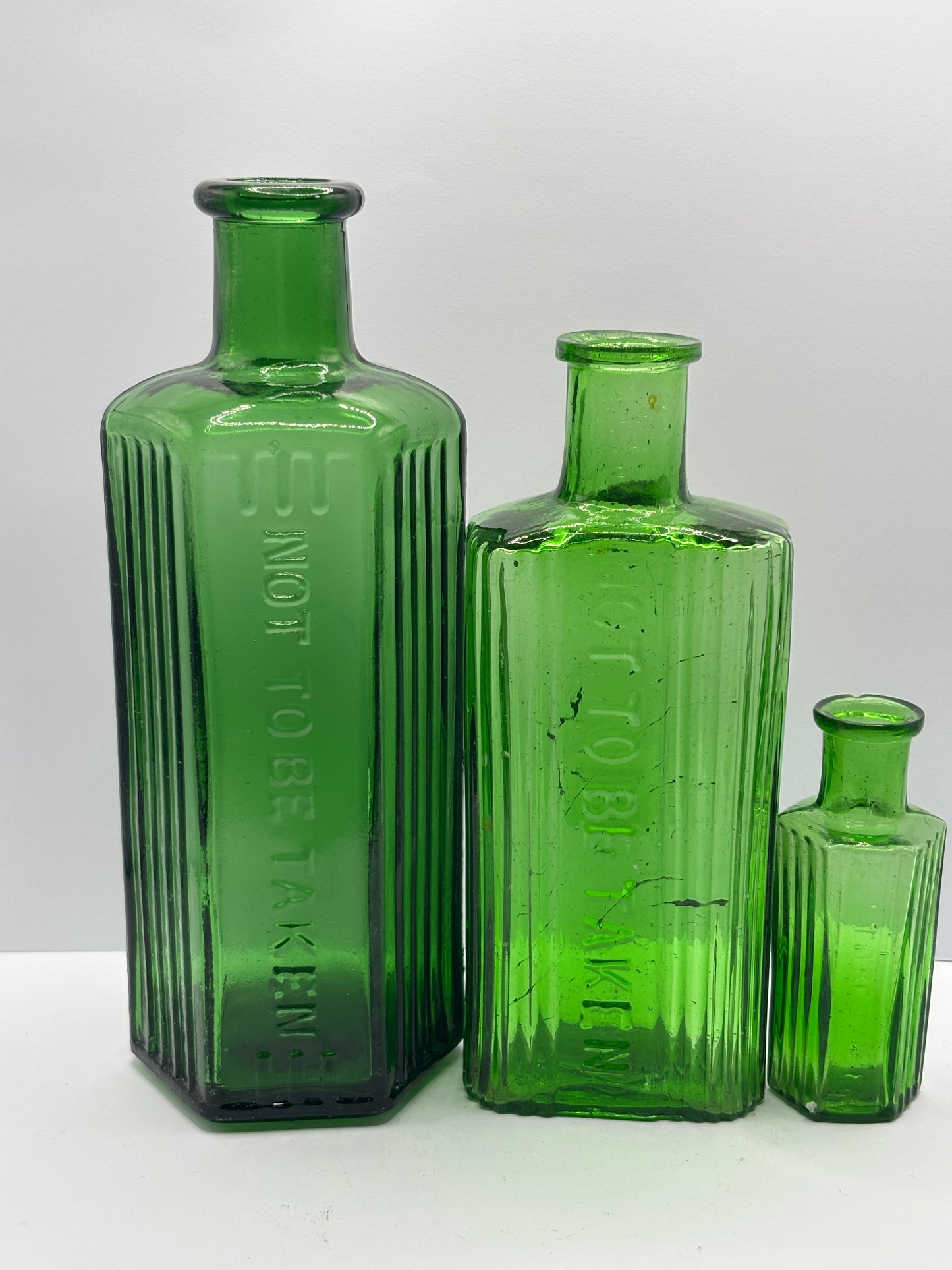 3 old green glass poison bottles, not to be taken