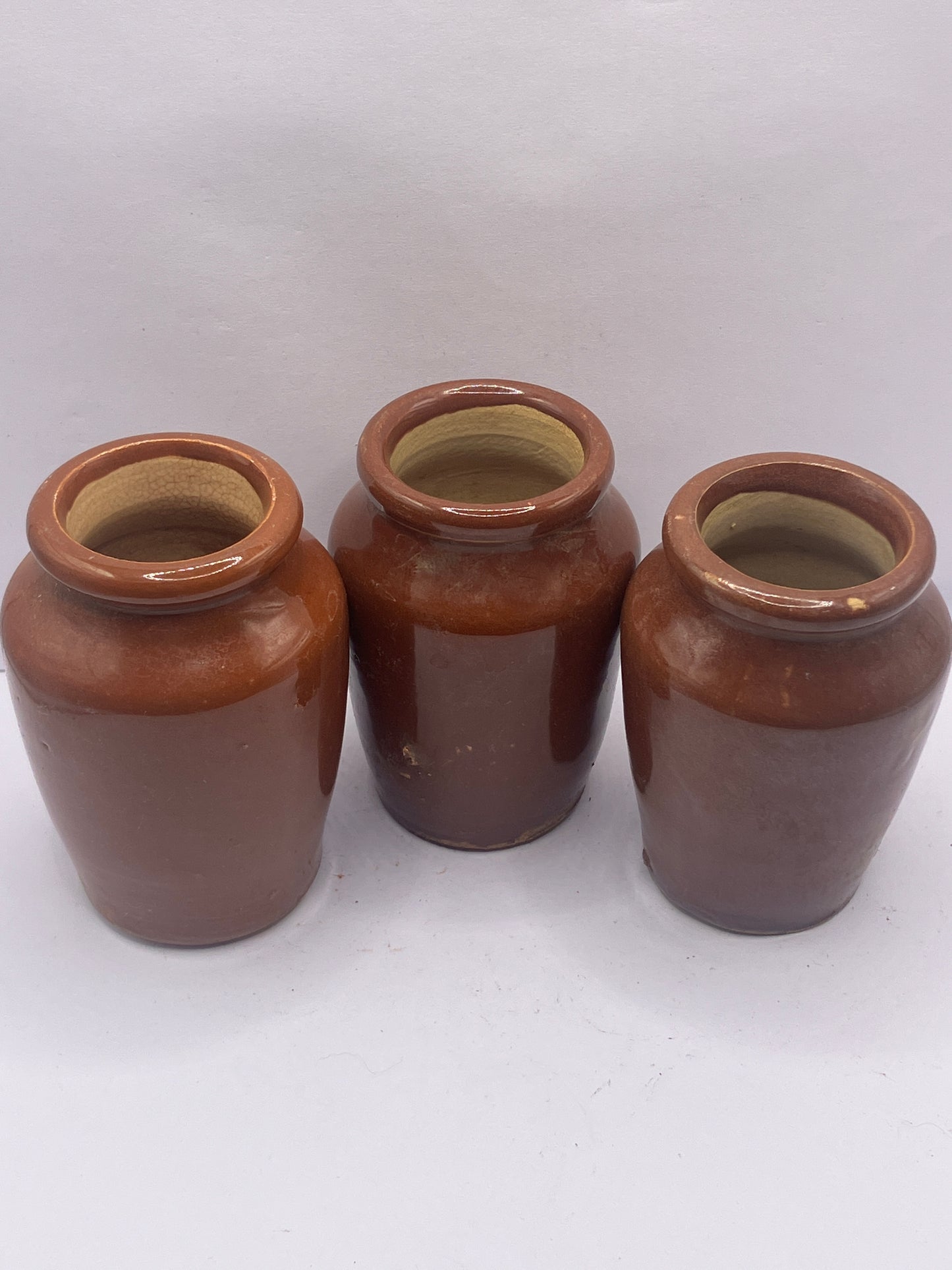 3 small brown stoneware cream pots