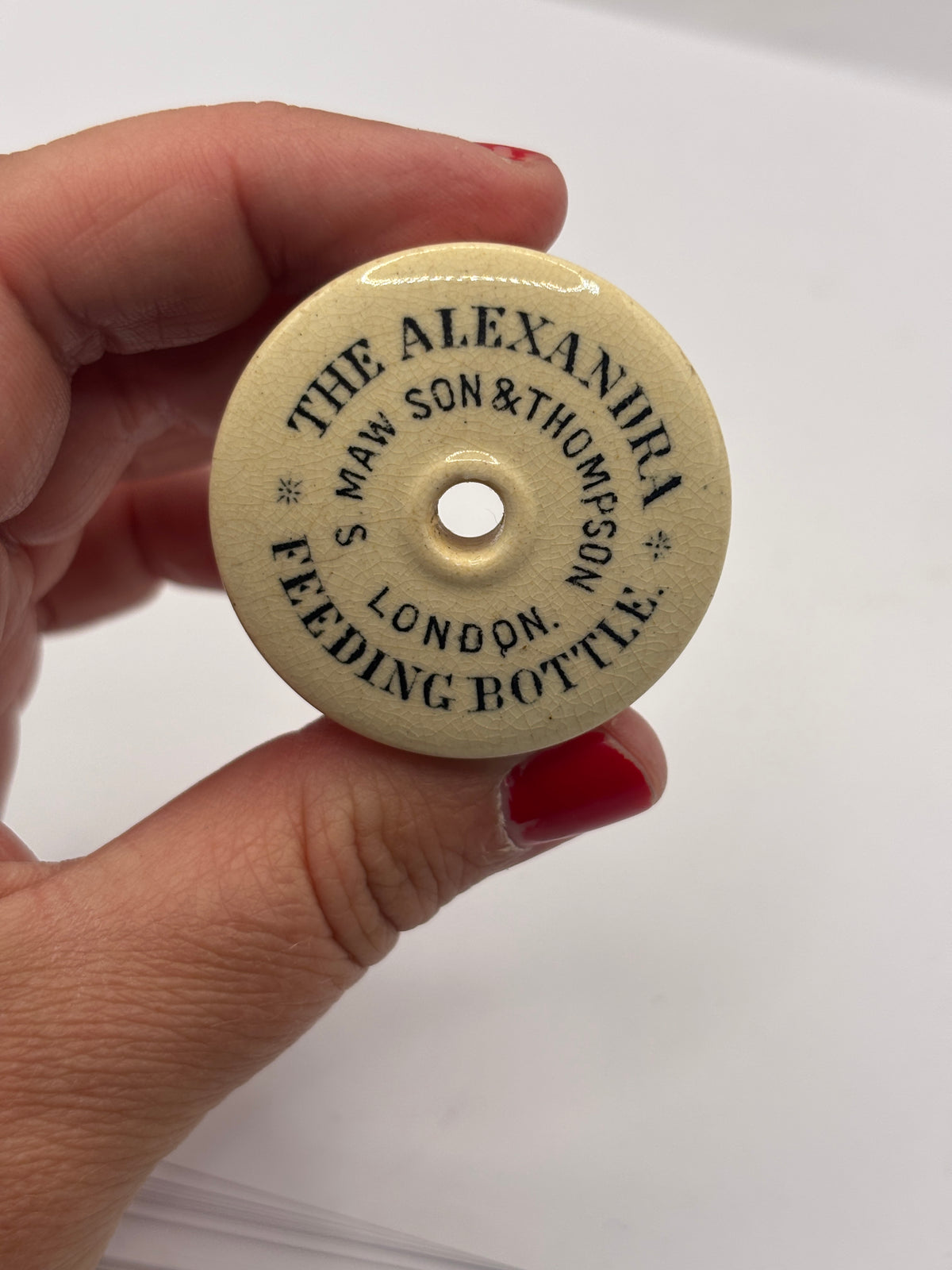 Old advertising baby feeder lid, Alexandra feeding bottle lid