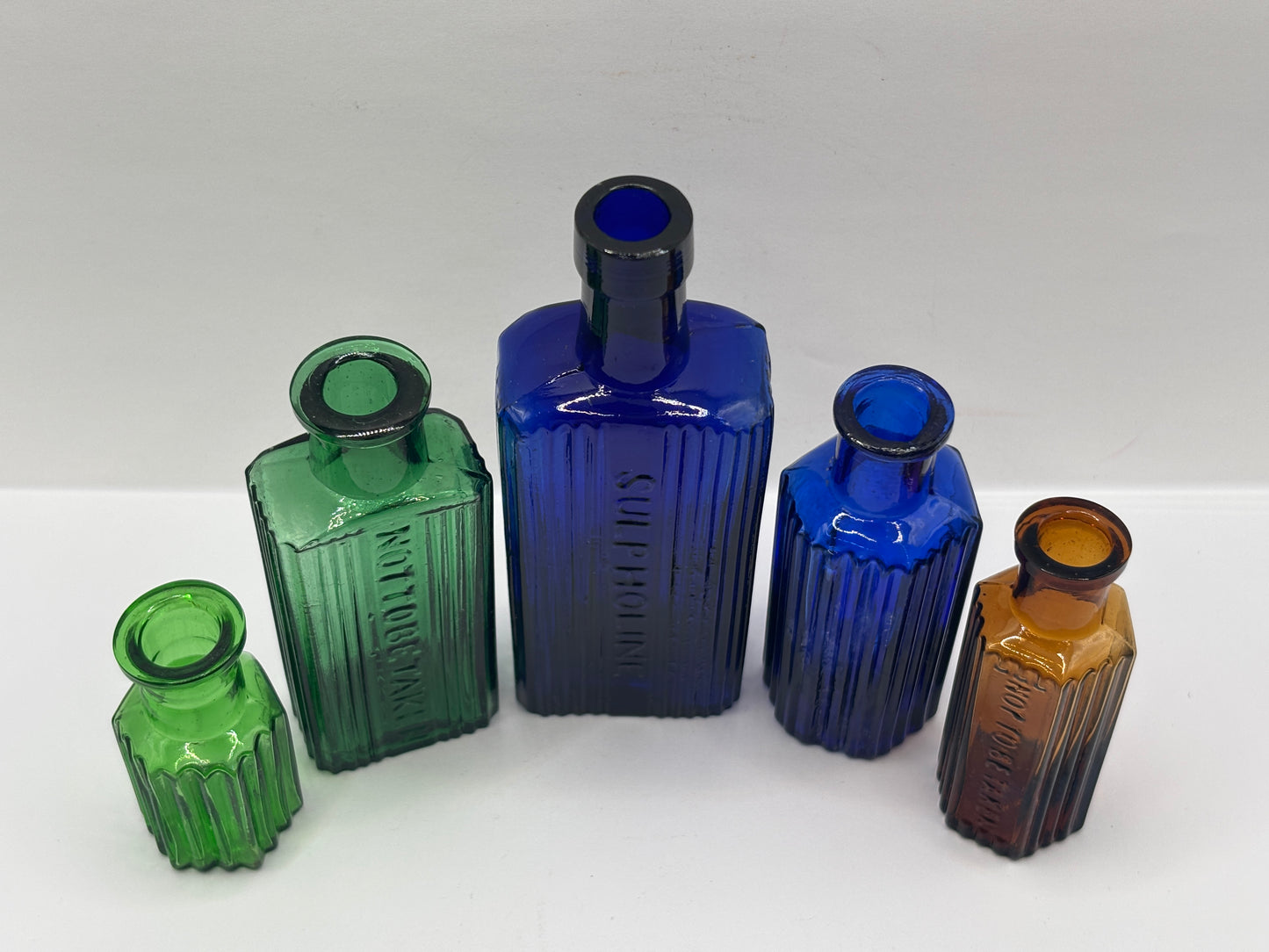 5 old glass poison bottles, not to be taken