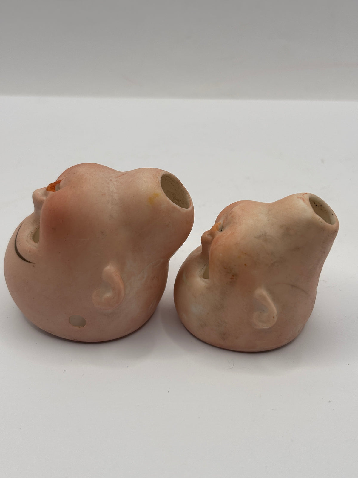 2 Old small bisque dolls heads. Damaged