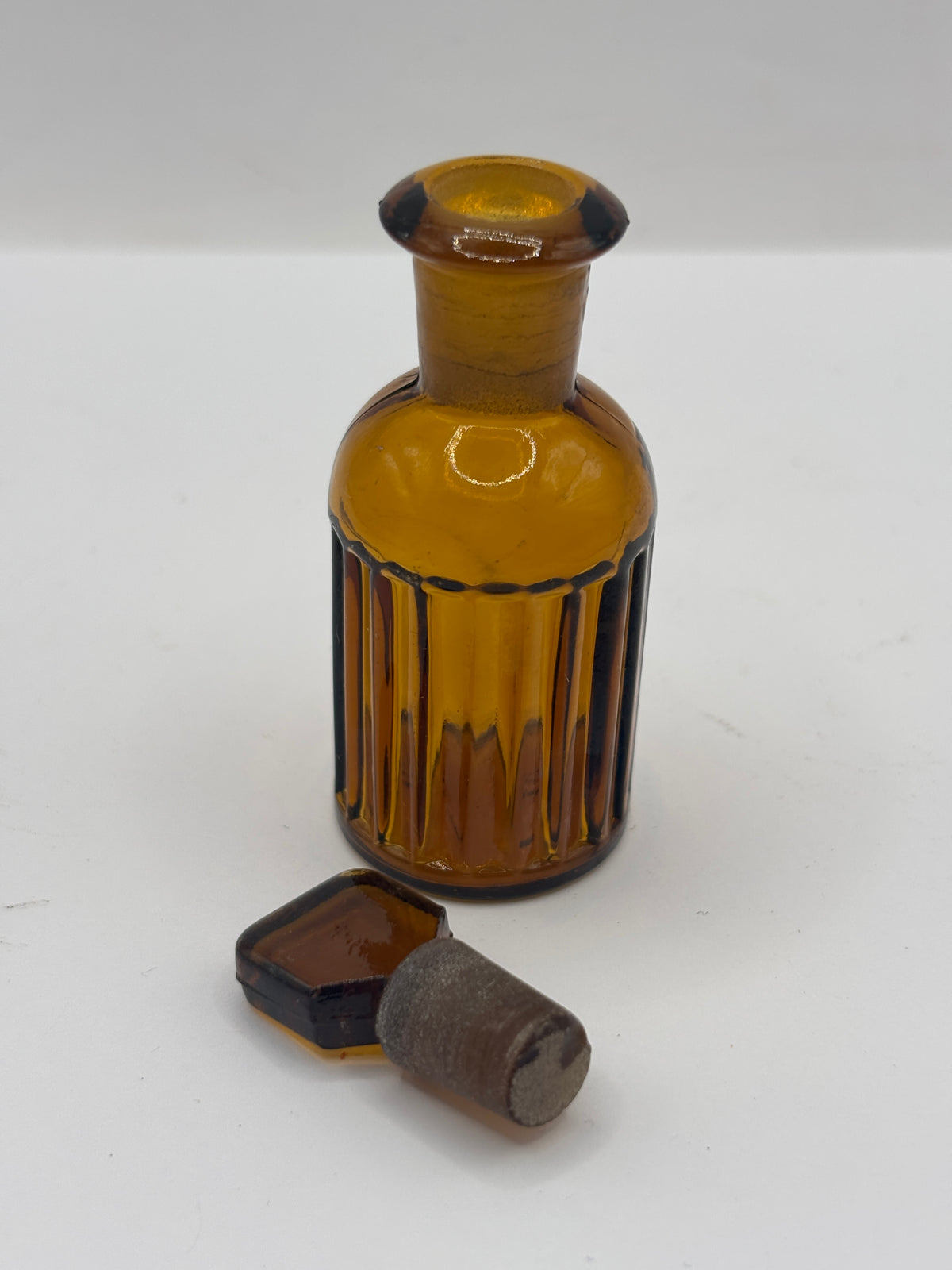 Small amber glass poison bottle with original stopper