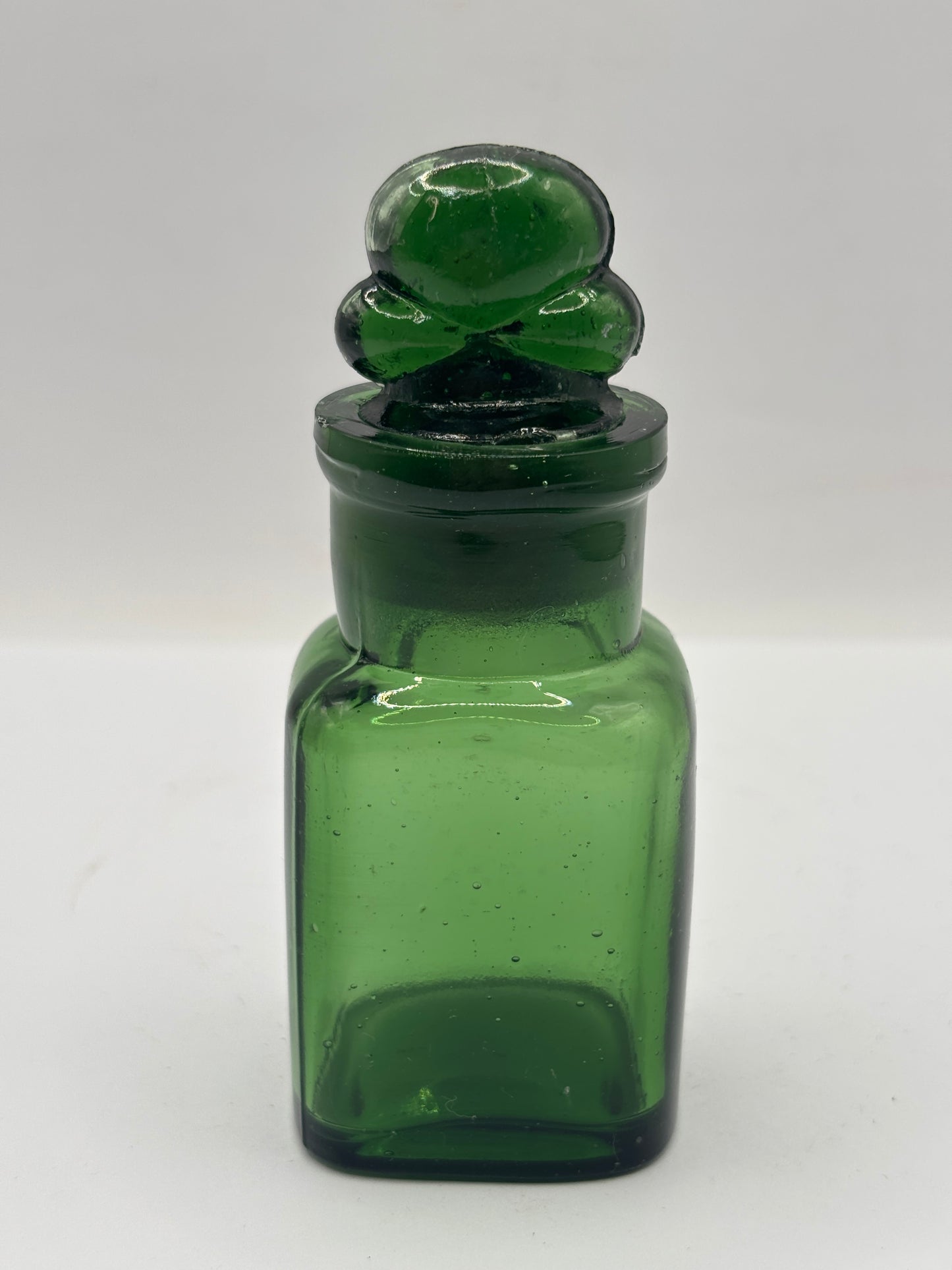 Old green glass smelling salts bottle, chipped