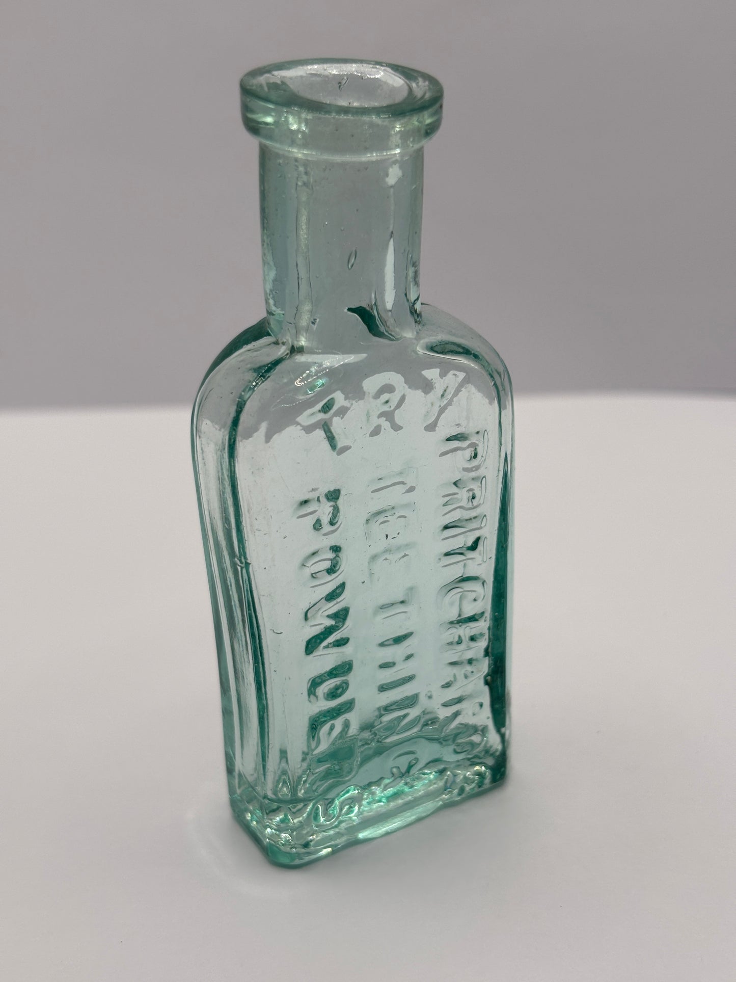 Old aqua glass advertising chemist bottle. Pritchards teething powder