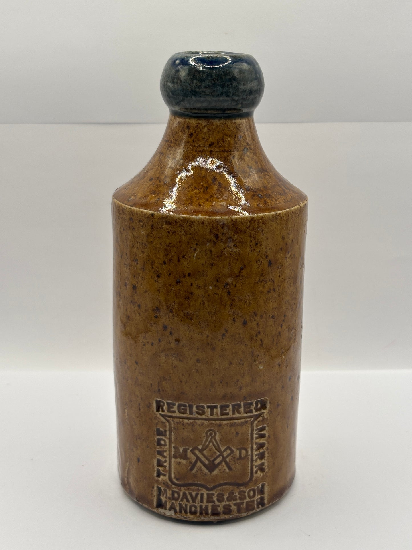 Old Blue top impressed stoneware ginger beer bottle, Manchester