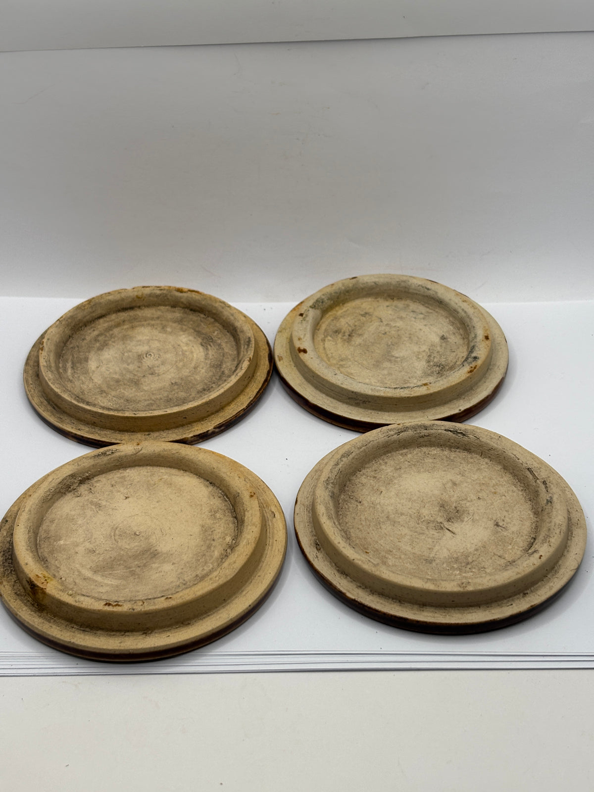 4 old brown stoneware lids, stackers