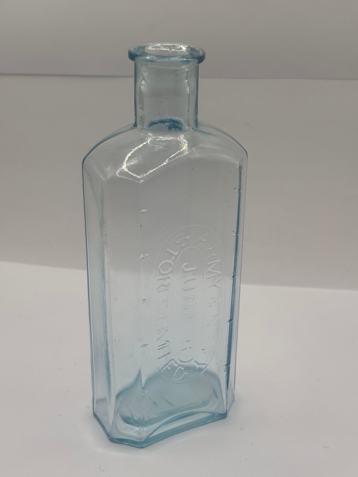 Old advertising chemist bottle. Army & navy junior stores