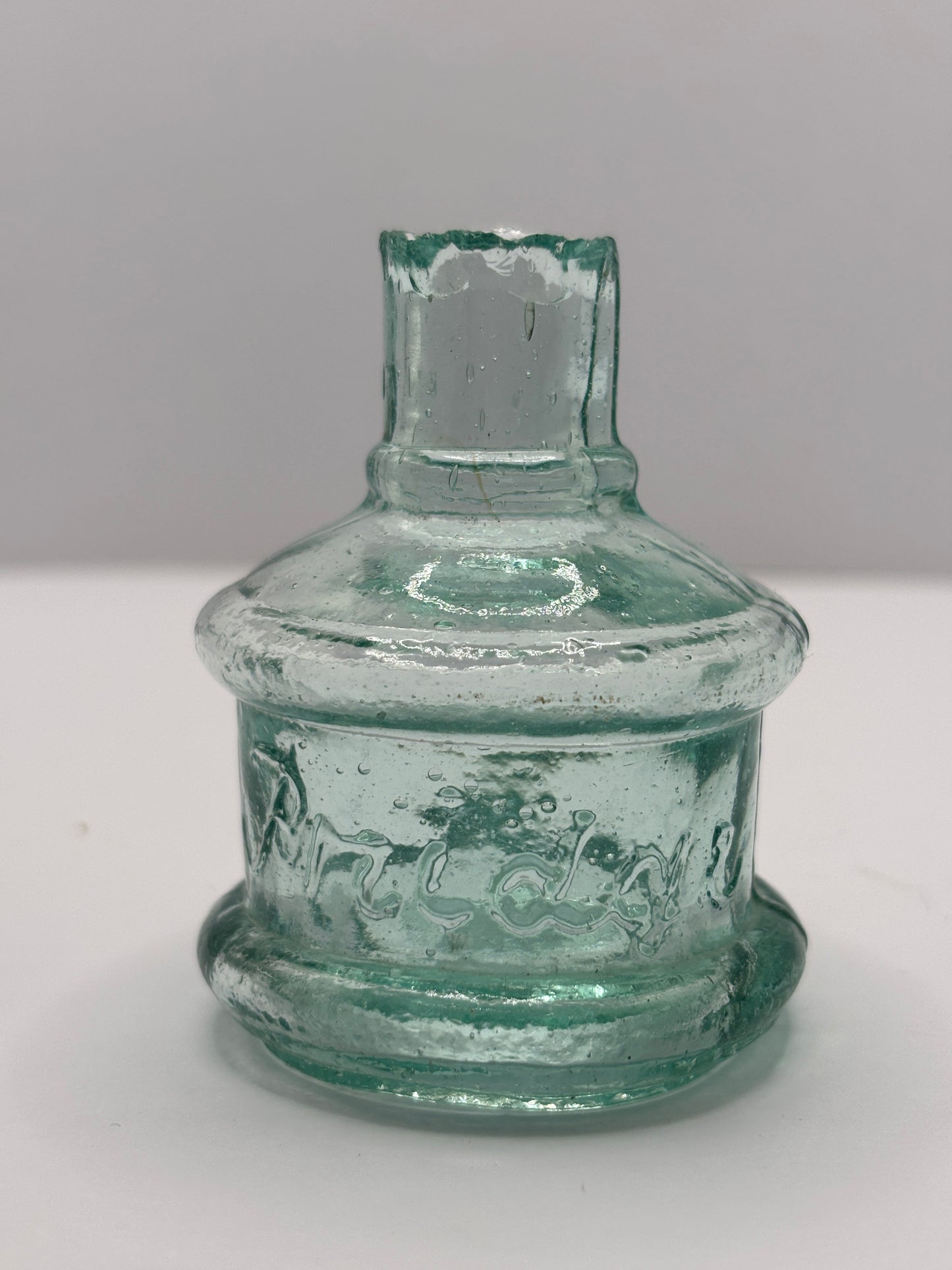 Old aqua glass advertising inkwell, ink bottle. Pridge