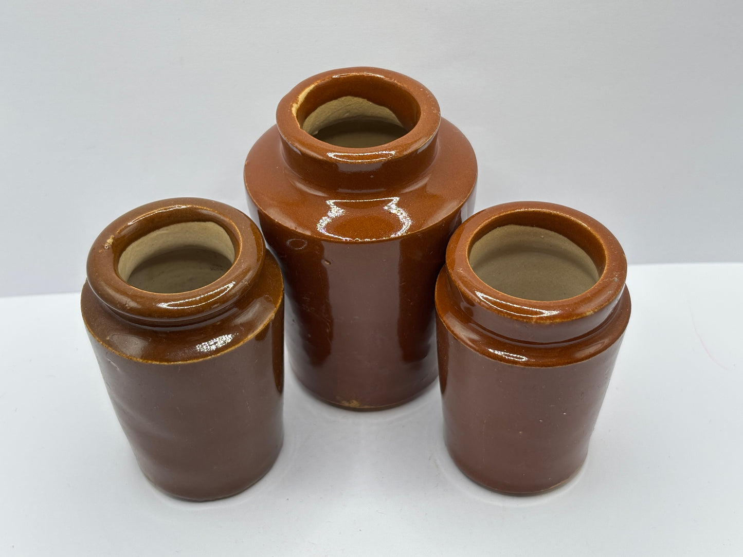 3 old brown stoneware cream pots