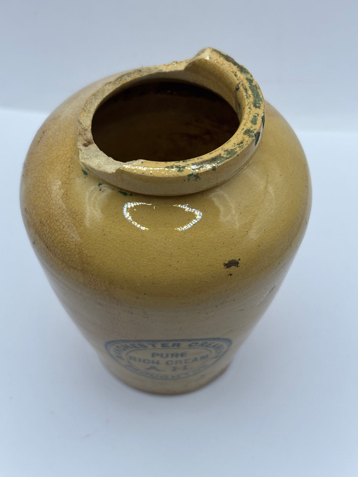 Old advertising cream pot,  Manchester creamery. Damaged